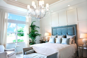 An elegant bedroom with a paneled wall.