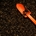 orange hand spade on soil