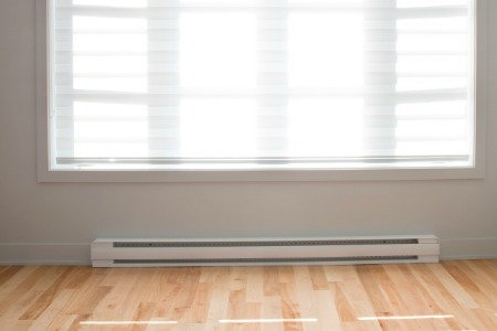 baseboard heater beneath a window