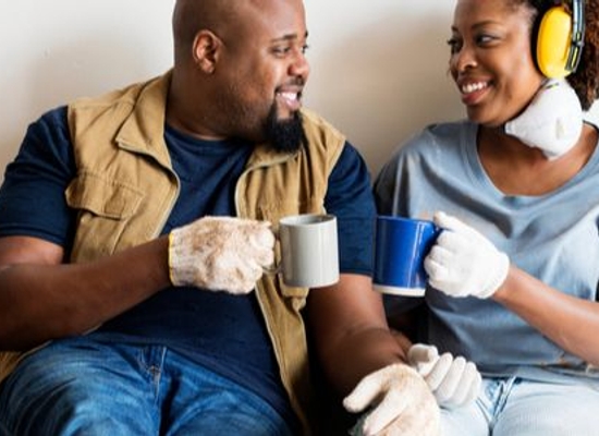 happy couple taking a coffee break during home improvement