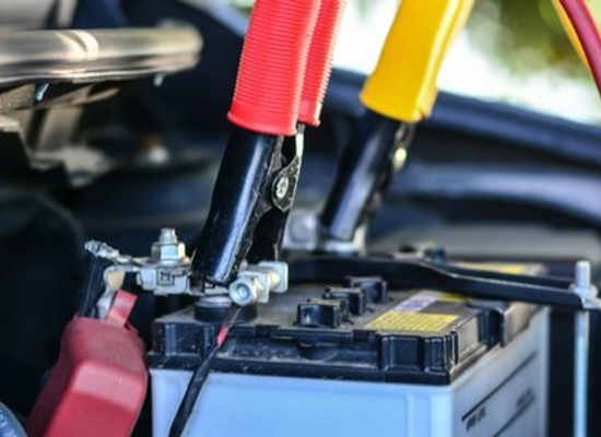 car battery with jumper cables attached