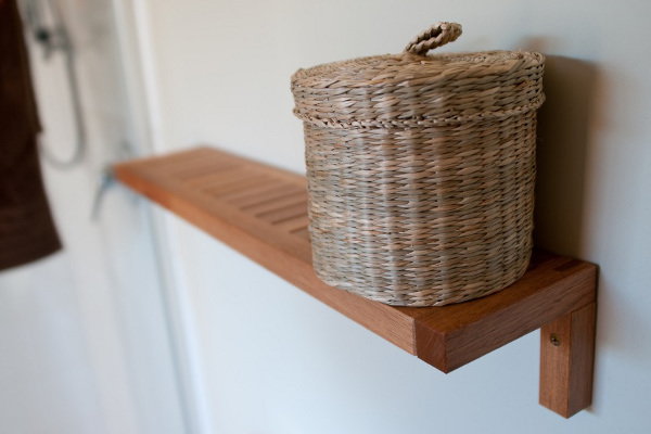 wooden shelf with basket on top