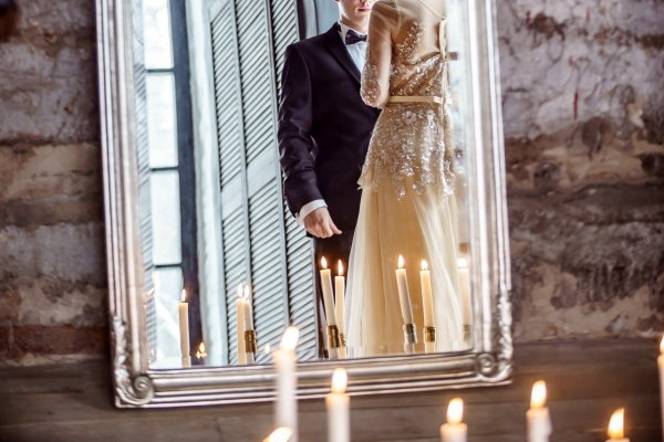 reflection in mirror of bride and groom