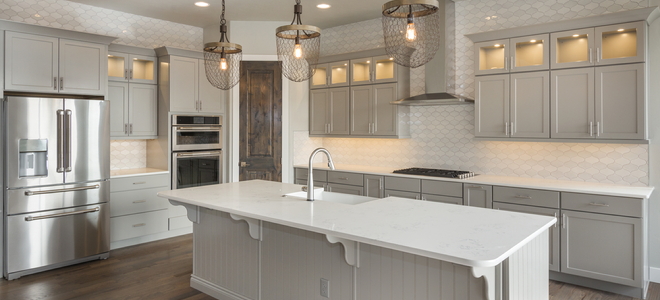 farmhouse kitchen with metal light fixtures and sink island