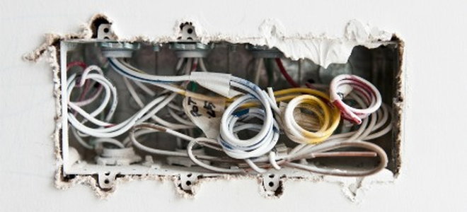 electrical box full of wires in the wall
