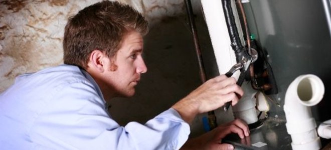 man repairing a furnace