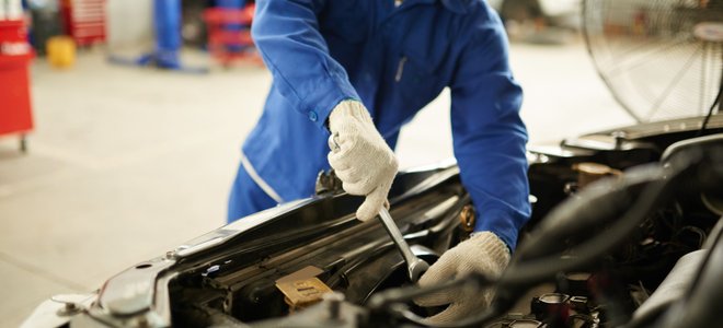 A man works on a car.