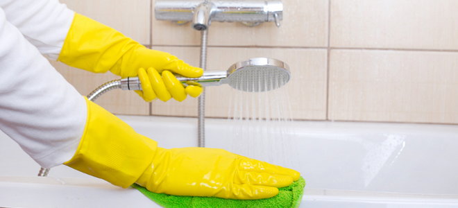 person cleaning a bathtub