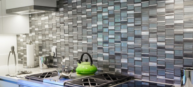 grey and white tile backsplash behind a stove