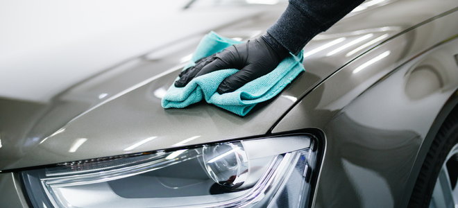A man cleans a car.