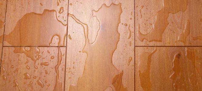 Wood flooring with water droplets on it.