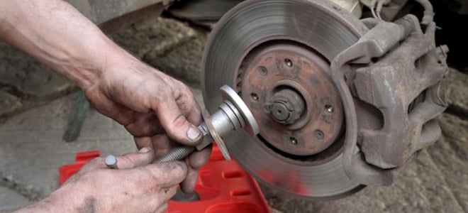 person working on automotive brakes