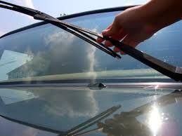 person holding windshield wiper