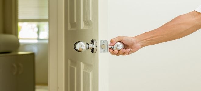 A hand opening or closing an interior door. 
