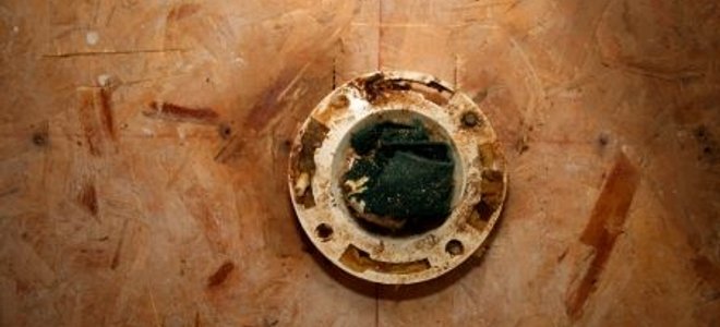 A closet flange sticking up through sub-flooring.