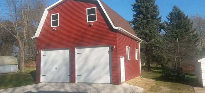 Red barn with white doors and trim