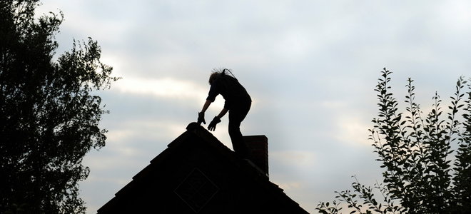 man on a roof at dusk