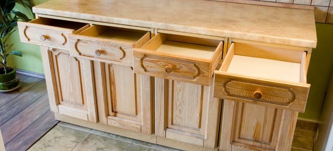 cabinet with a row of open drawers and cupboards below
