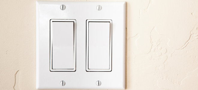 A contemporary style dual light switch on a wall.