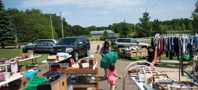 A woman and a child at a garage sale.