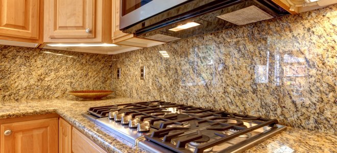 An over-the-range microwave in a granite kitchen.