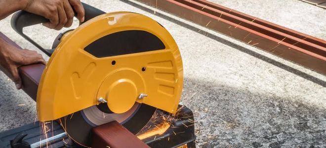 A man uses a circular saw.
