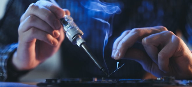hands soldering smoking material