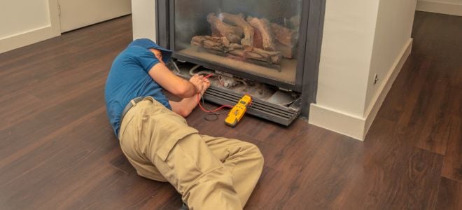 man fixing gas fireplace