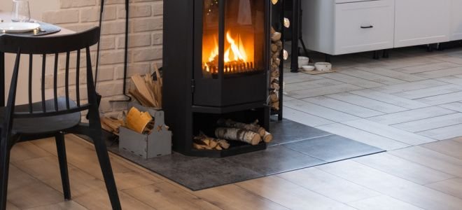 small wood stove on hearth pad