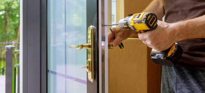 hands with drill fixing door handle