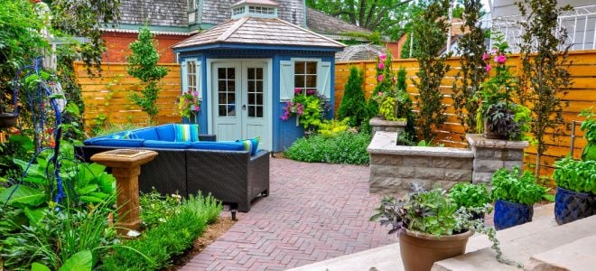 pretty brick patio with couch and shed