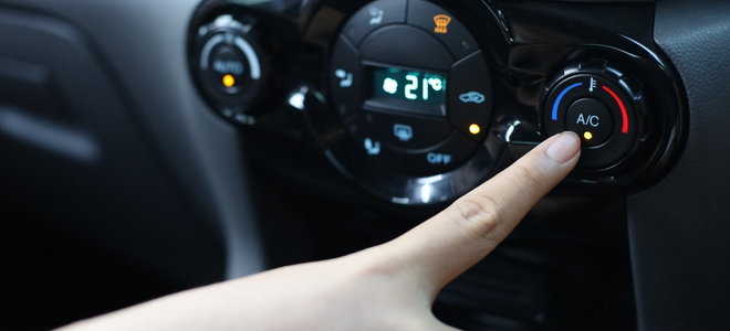 hand pressing car AC heating button
