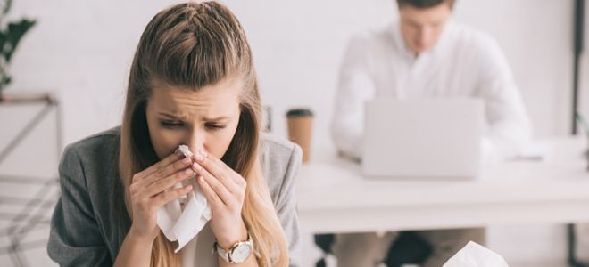 woman using tissue in office