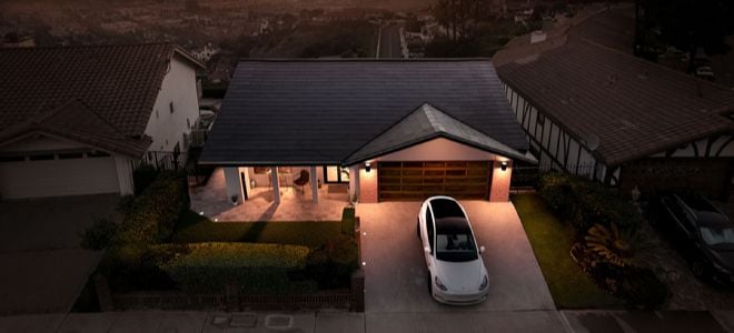 Tesla solar shingles on house with Tesla car