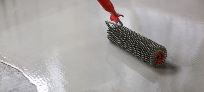 rolling a coating onto concrete