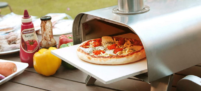 pizza oven with pizza and toppings