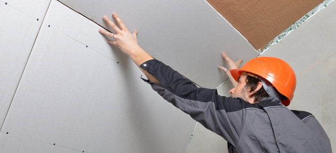 man installing drywall