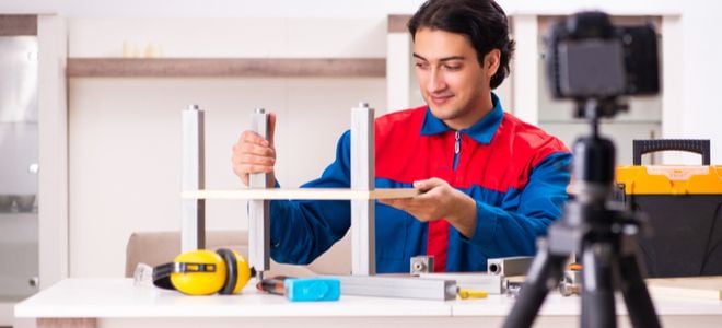 man constructing item in front of camera