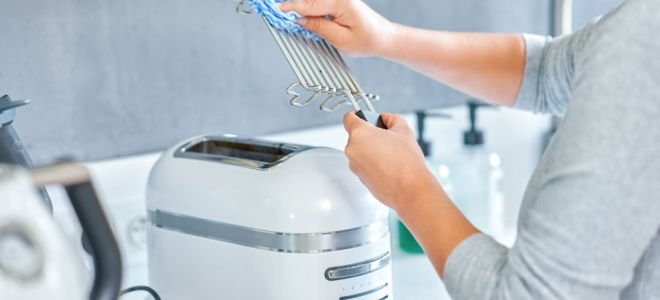 hands cleaning toaster