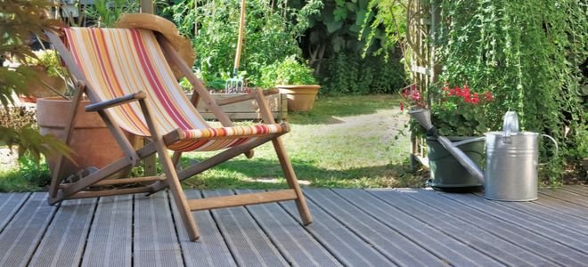 exterior patio deck space with chair next to garden