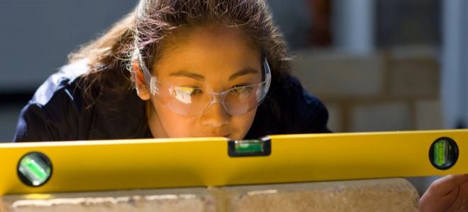 young woman looking at level with goggles