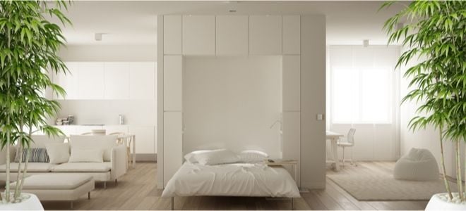 white wall bed in the middle of an open white room