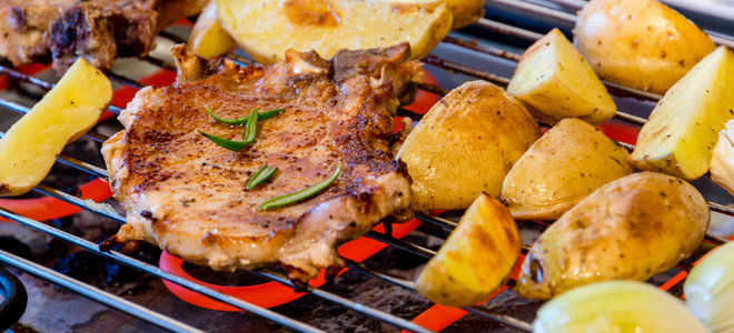 meat and potatoes cooking on an electric grill
