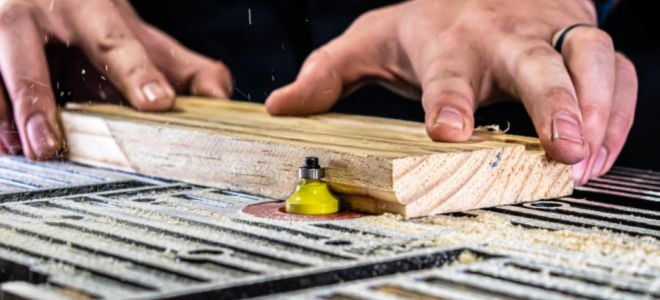hands cutting wood trim