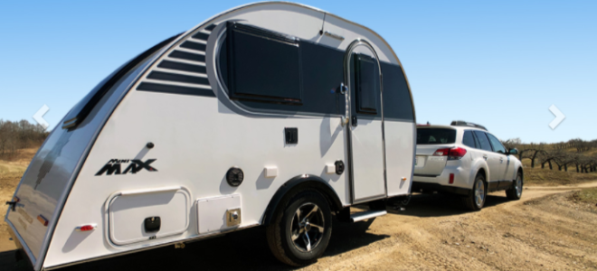 curved camper trailer behind car