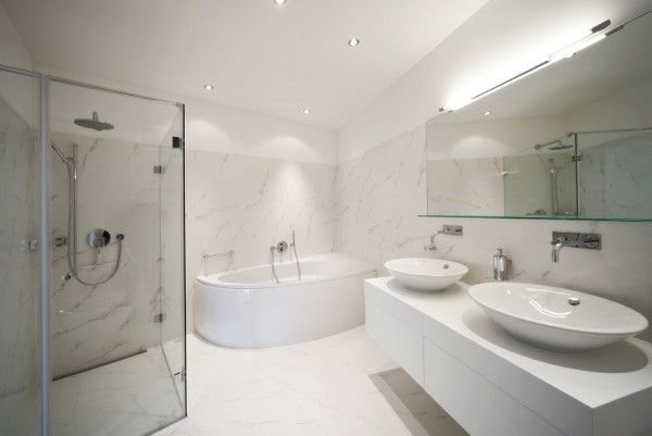 Large bathroom with glass shower and white furnishings