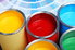 various colorful paint cans and paint chips