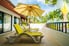 Deck with yellow lounge chairs and large umbrella