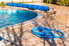 a backyard pool with hose laying on the patio