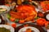 A turkey and other Thanksgiving dishes on a table decorated with pumpkins.